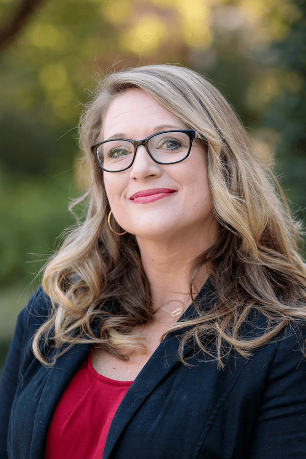 Headshot of Wendy Hoggle in front of greenery